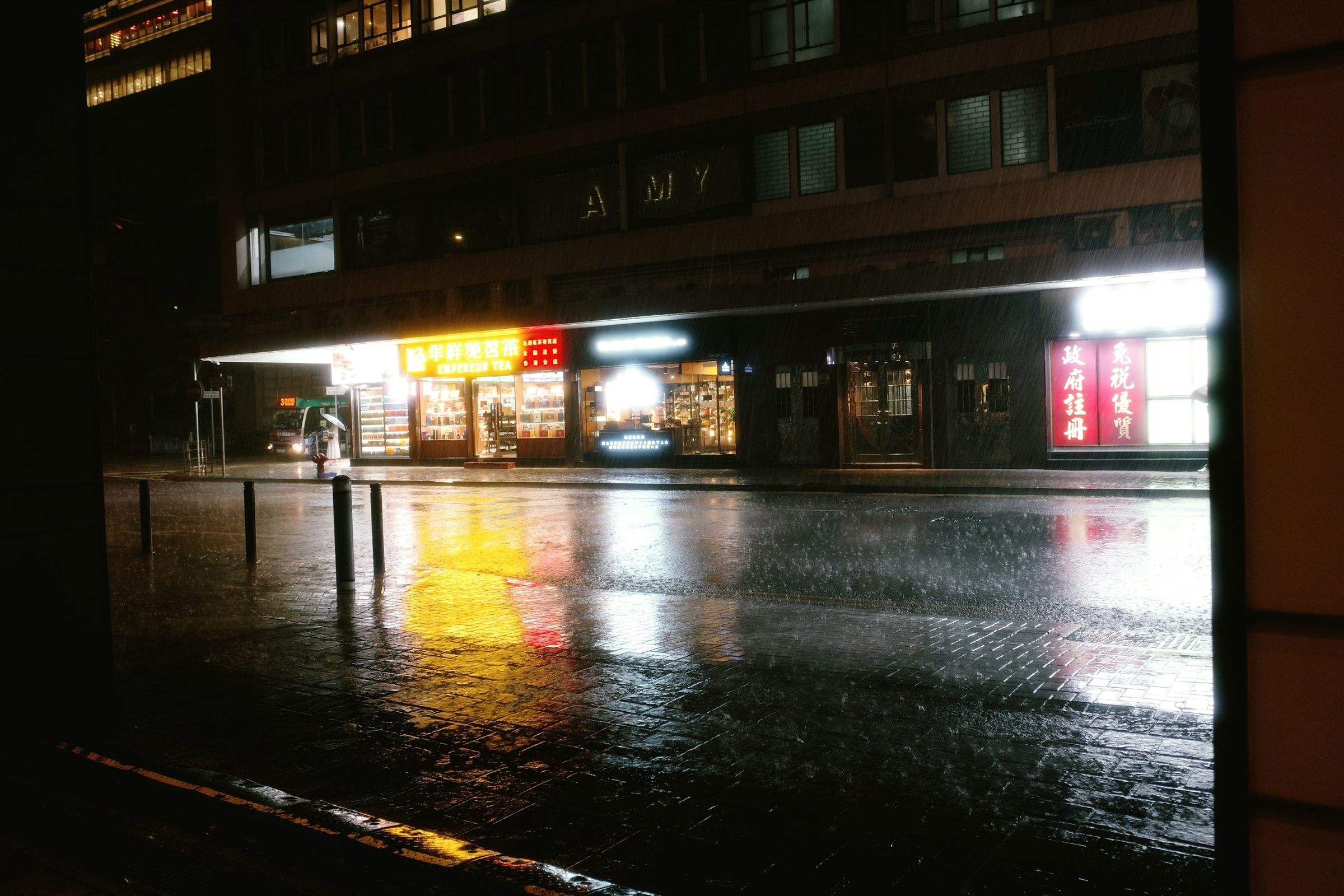 Rain-slicked street at night with reflected lights