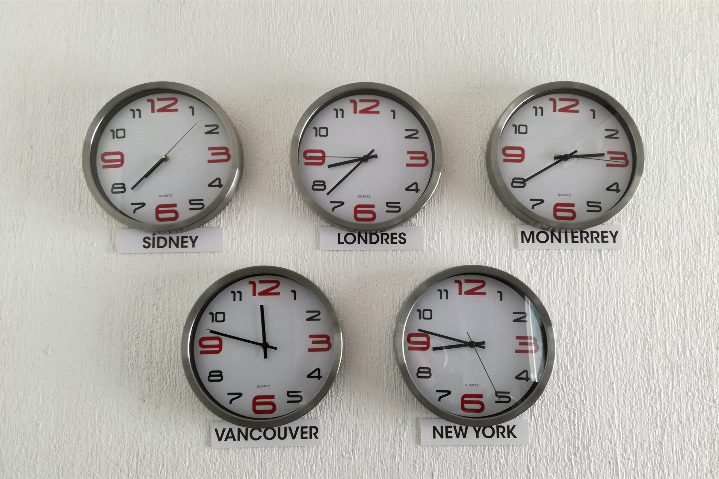 World time-zone wall clocks including Vancouver and New York