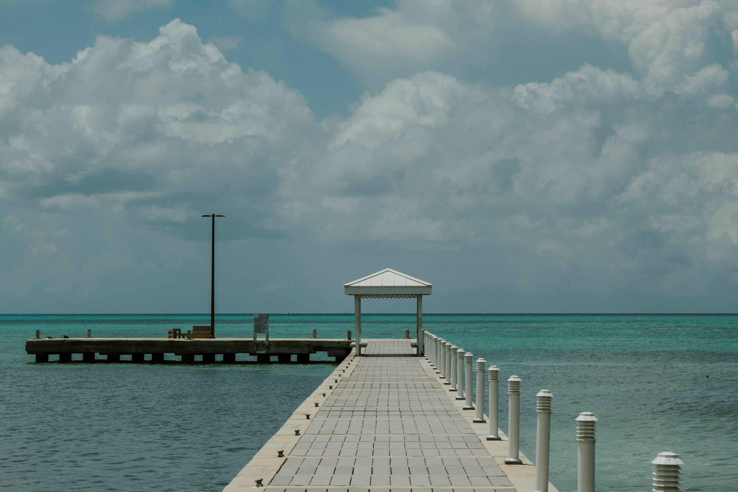 Wooden pier with gazebo over calm Grand Cayman water