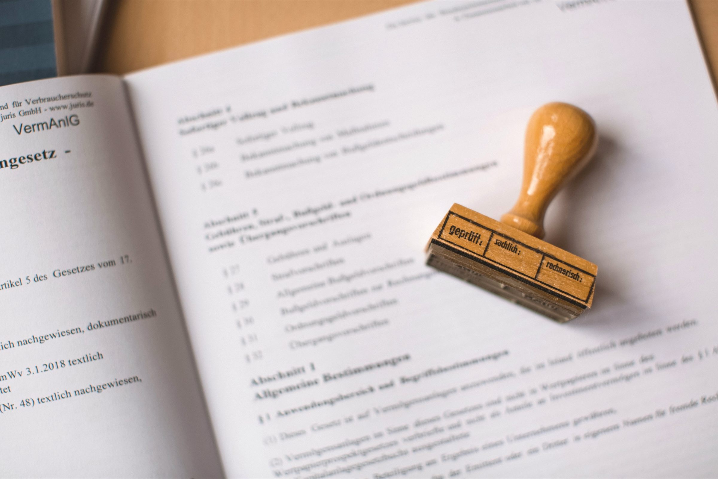 Wooden rubber stamp resting on an open legal document