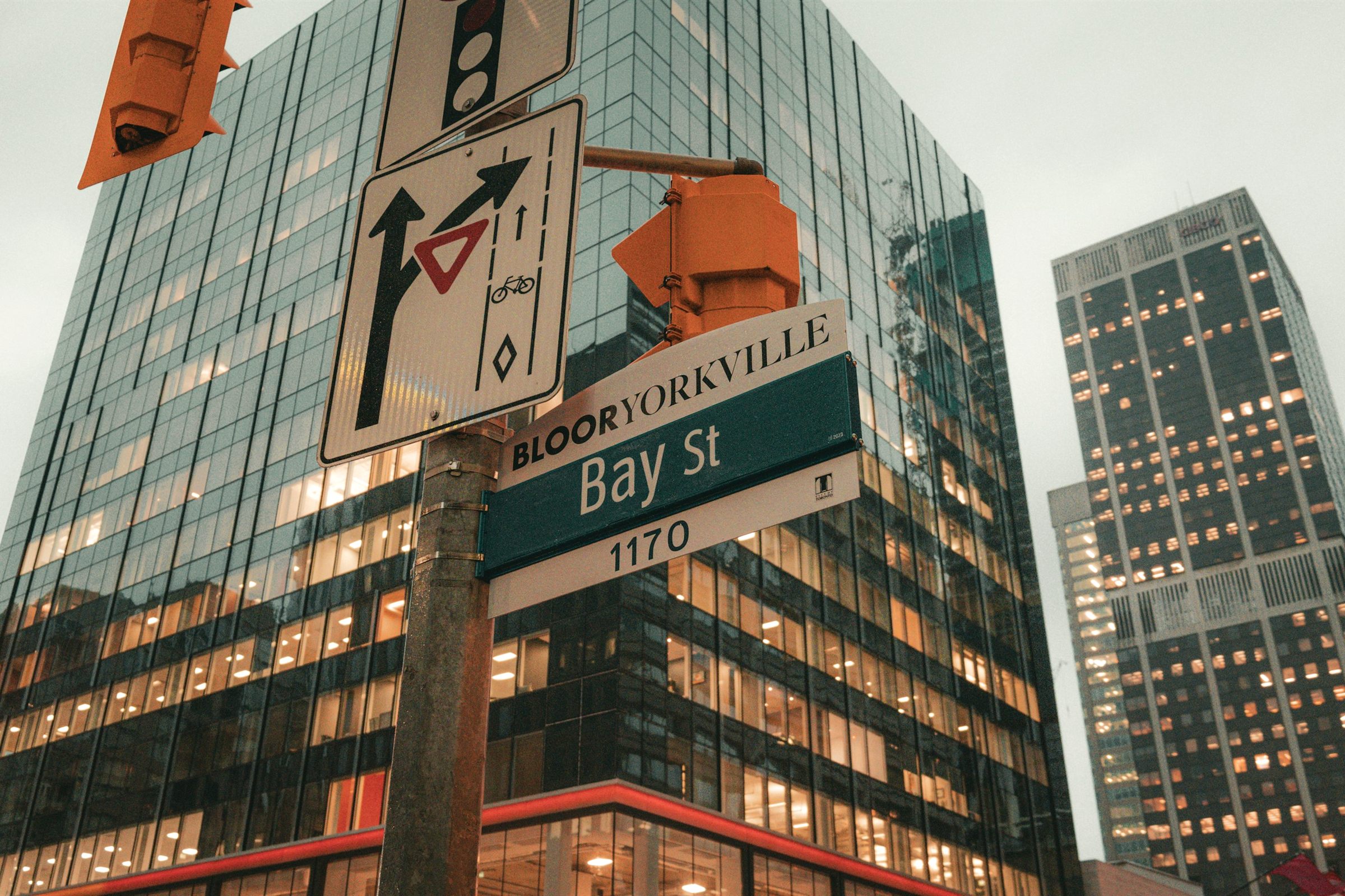 Bay Street sign beneath Toronto glass office towers