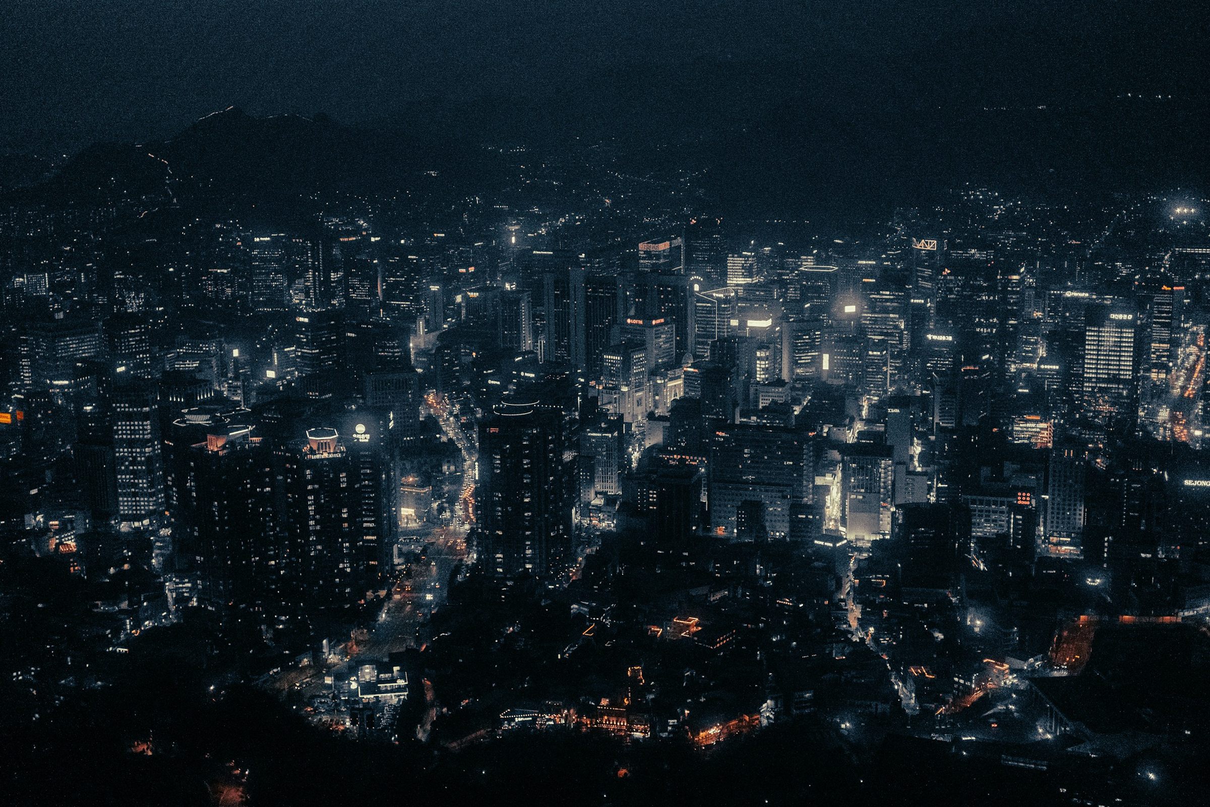 Dark night city panorama seen from a hilltop
