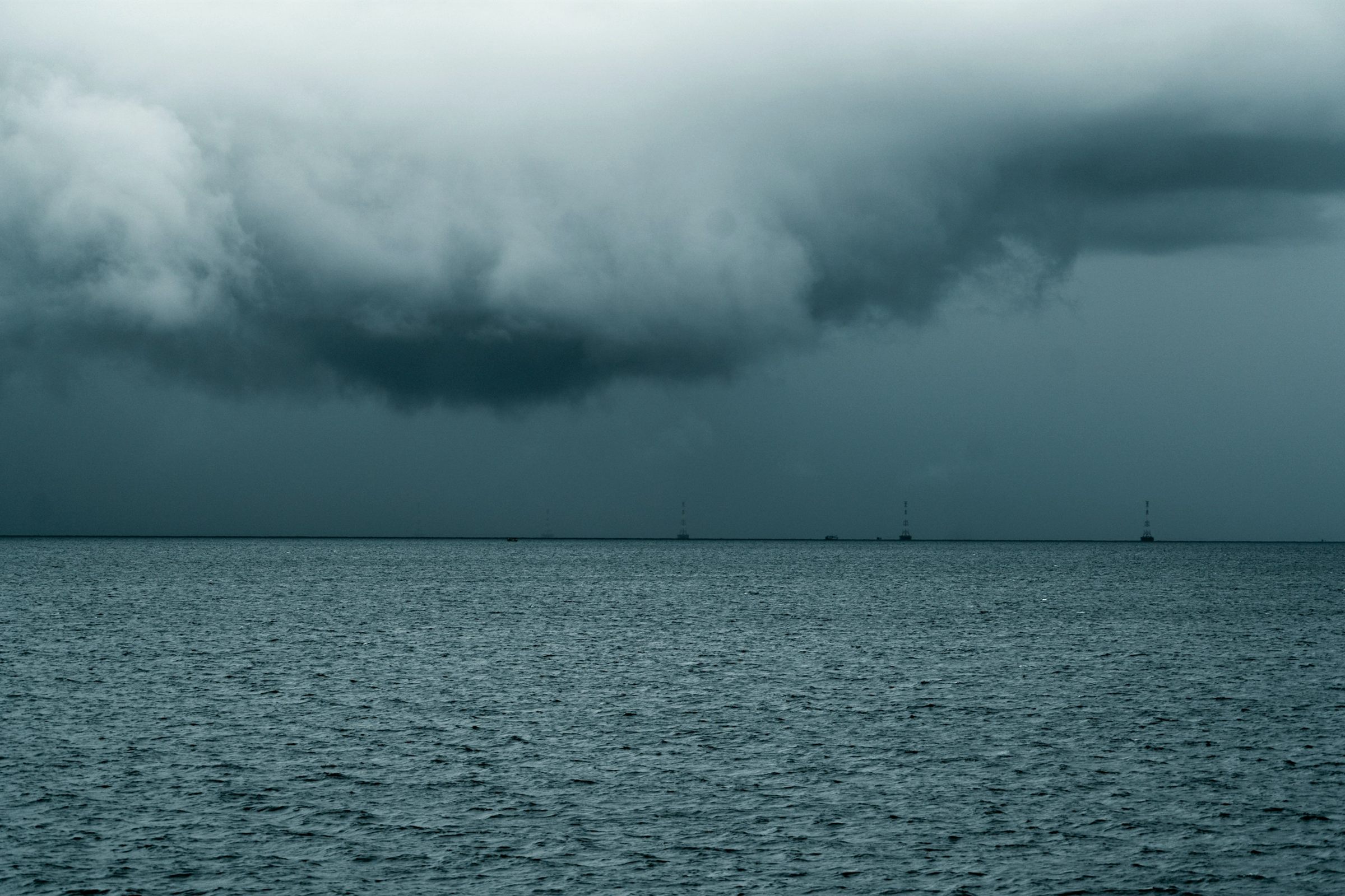 Storm clouds gathering over a grey-green sea