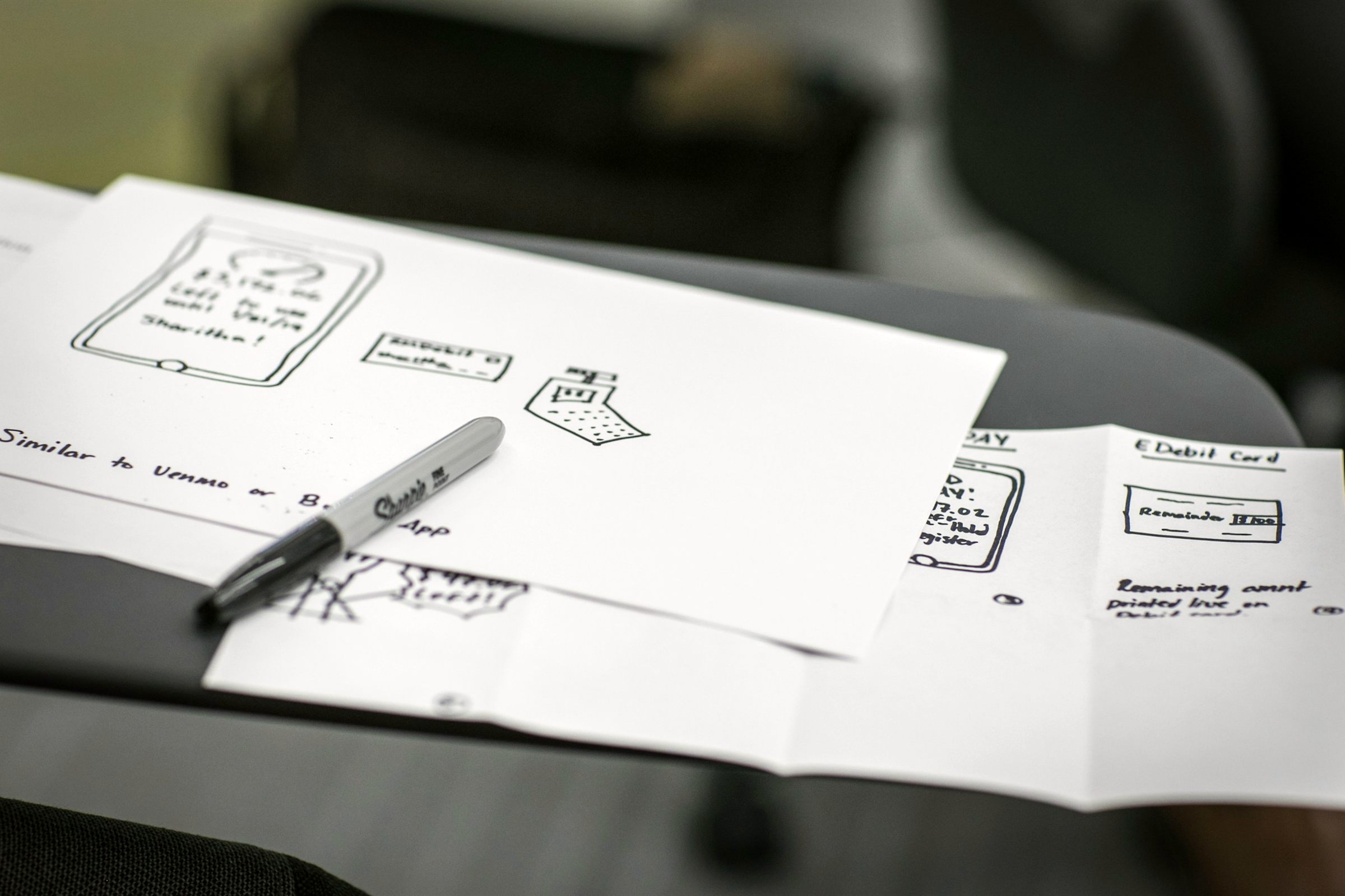 Hand-drawn box diagrams on paper with a marker