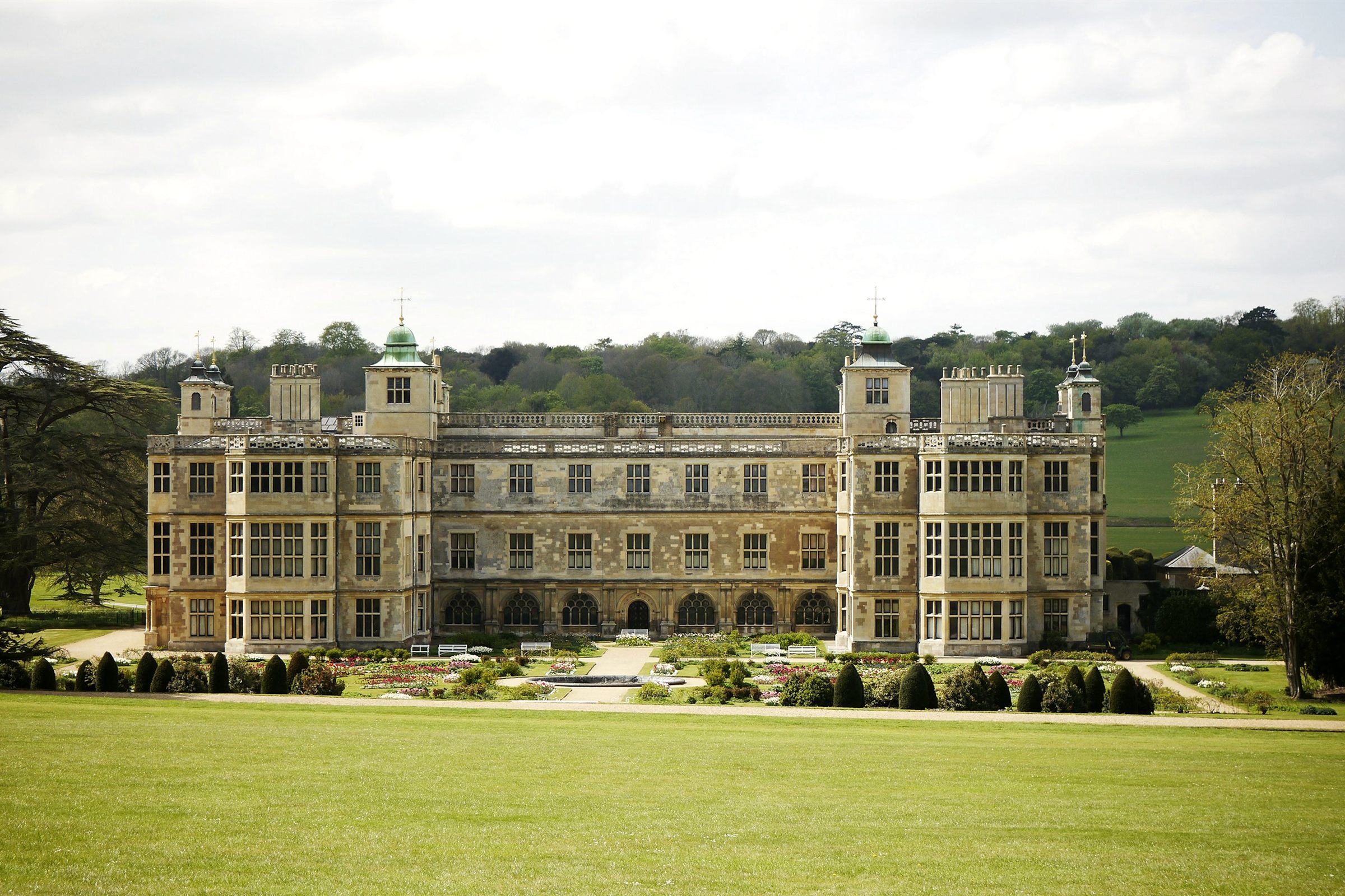 Grand historic English manor house with formal garden and lawn