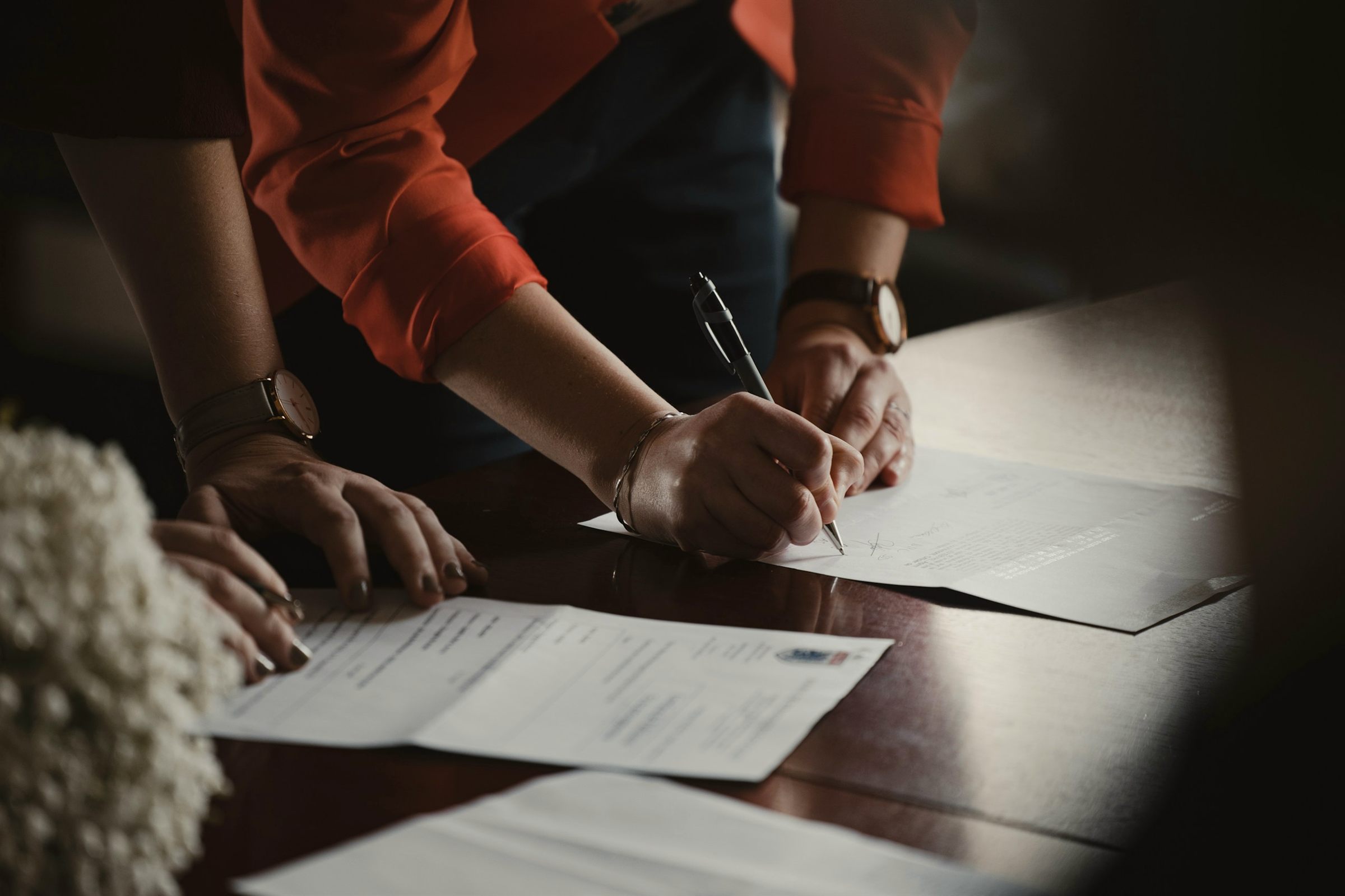 Signing papers at a desk